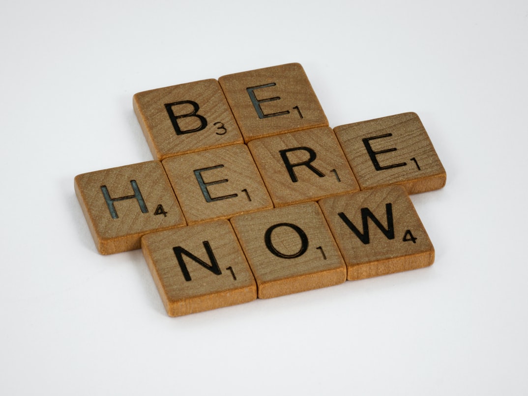 logo saying be here now
